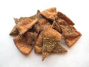 Baked pita chips in a pile.