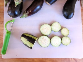Slicing eggplant into rounds.