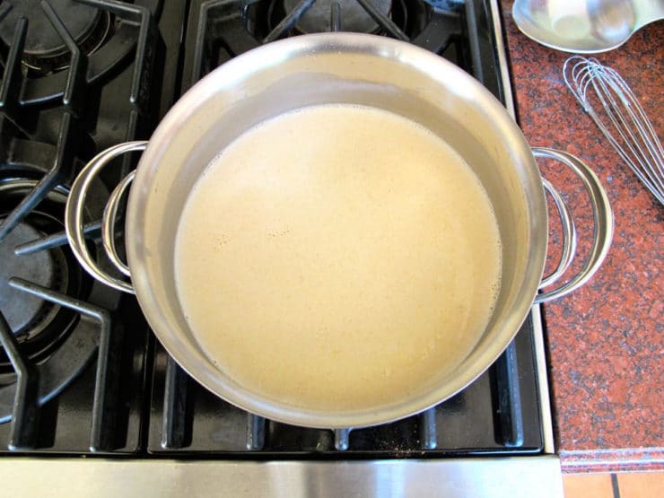 Bechamel sauce simmering on the stove.