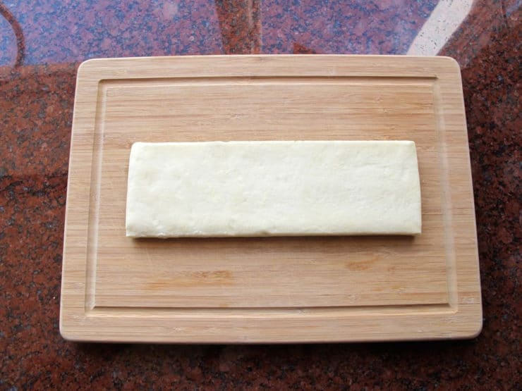Puff pastry on a cutting board.