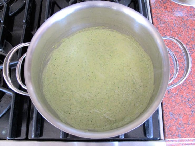 Basil mixture stirred into roux in a saucepan.