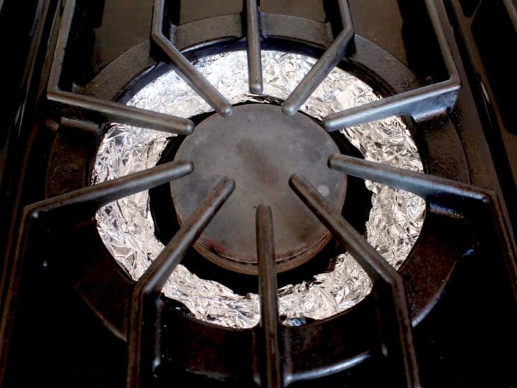 Stove burner lined with foil.