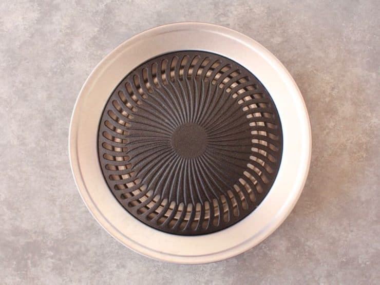 Grill pan on concrete background.