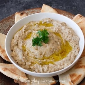 Classic Baba Ghanoush - Recipe for smoky Middle Eastern roasted eggplant dip with tahini, garlic, lemon, olive oil and spices.