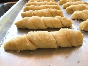 Sour cream twists on a baking sheet.