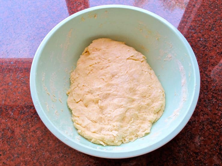 Dough combined in a mixing bowl.