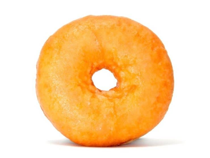 Plain doughnut standing on a white background. 