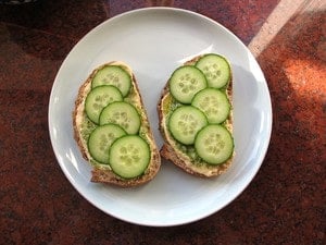 Sliced cucumbers on sliced bread.
