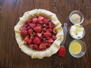 Strawberry pie filling poured into bottom crust.