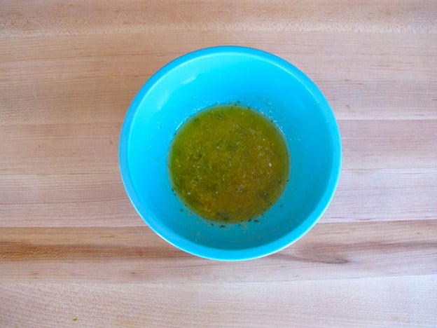 Seasonings whisked into a bowl of melted butter.