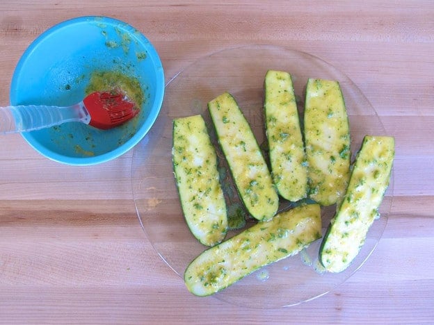Baste zucchini halves with melted butter.