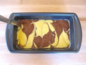 Small rectangular cake pan with two swirled batters.