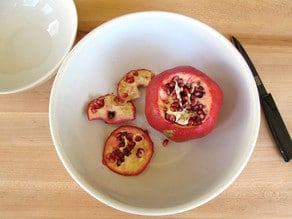 Slice bottom end off pomegranate.