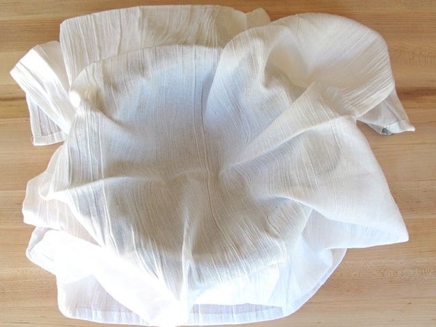 Tea towel-lined mesh colander.
