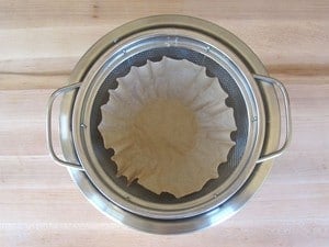 Coffee filter-lined mesh colander.