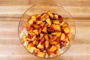 Diced peaches added to trifle dish.