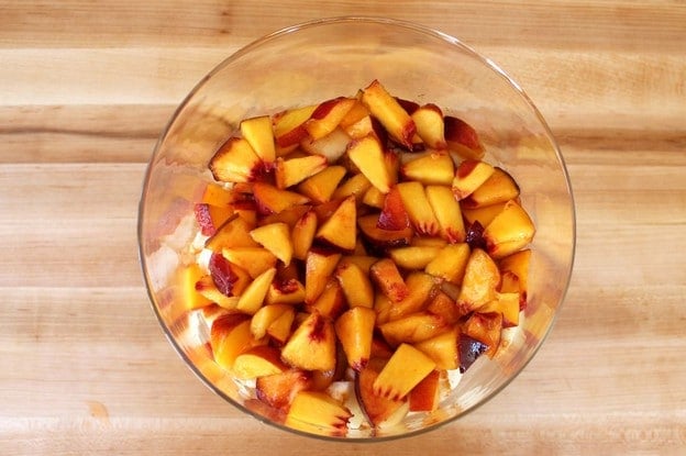 Diced peaches added to trifle dish.