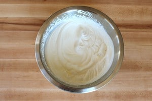 Cream beaten to stiff peaks in a bowl.