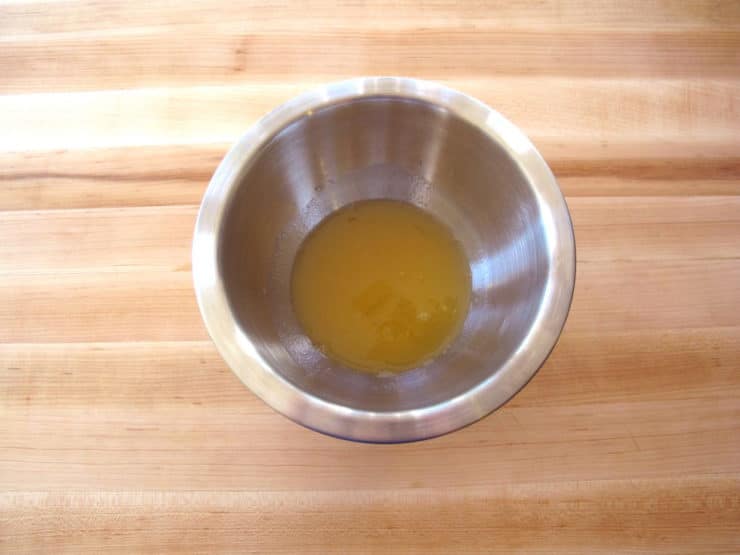 Peach nectar and rum in a small bowl.