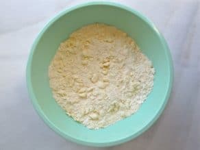 Small crumbles of butter in dry ingredients in mixing bowl.