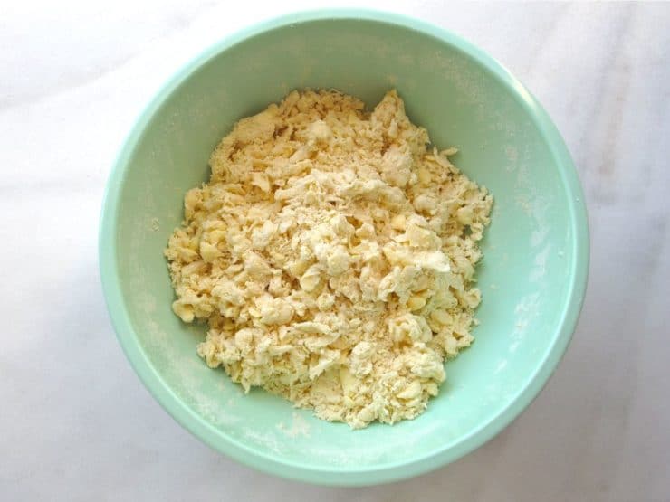 Cold water added to dry ingredients, crumbly wispy dough in mixing bowl.