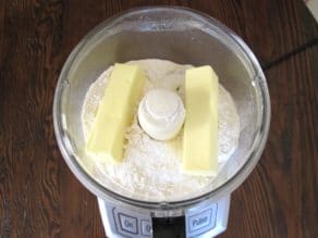 Two sticks of butter in flour in food processor.