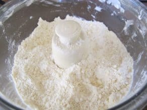Pulsed flour with butter crumbles in food processor.