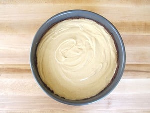 Cheesecake filling poured into springform pan.