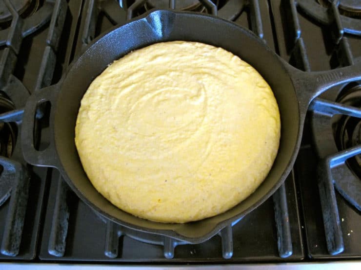 Cornbread batter poured into hot cast iron skillet.