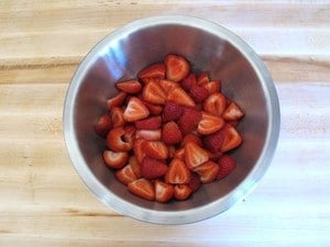 Sliced strawberries in a large mixing bowl.
