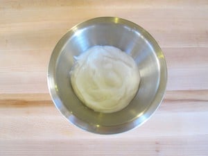 Strained yogurt in a mixing bowl.