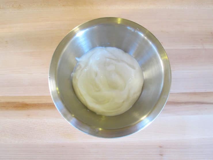 Strained yogurt in a mixing bowl.