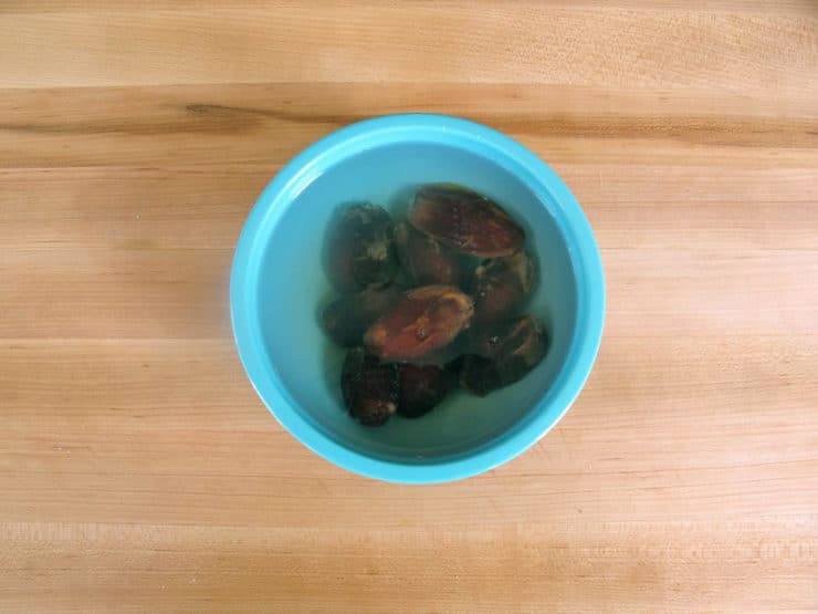 Dates soaking in a bowl of warm water.