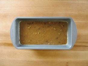 Batter poured into a greased loaf pan.