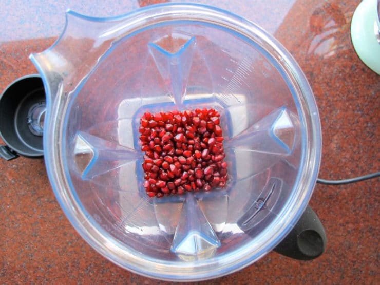 Pomegranate seeds in a blender jar.