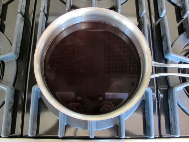 Pomegranate juice in a saucepan.