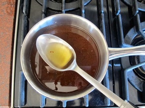 Scoop fat off the top of the pan drippings in a saucepan.