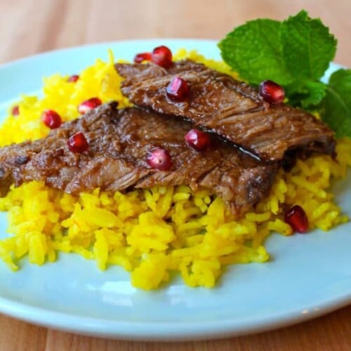Delicious pomegranate-spiced beef with rice, topped with Pomegranate Molasses Brisket