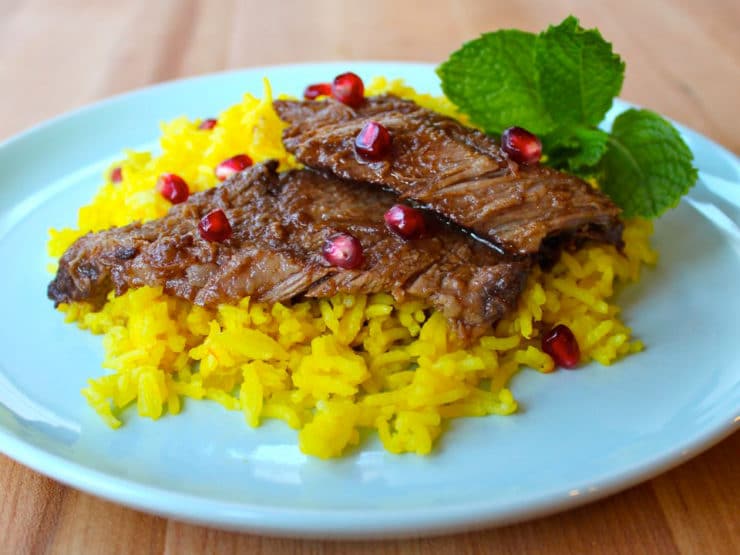 Delicious pomegranate-spiced beef with rice, topped with Pomegranate Molasses Brisket