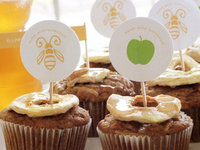 Honey Apple Cupcakes topped with printed bee and apple icons on a toothpick