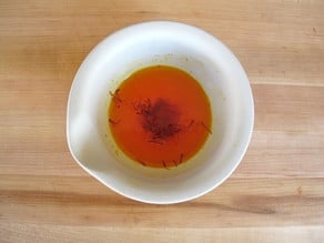 Warm water added to saffron in a mortar.