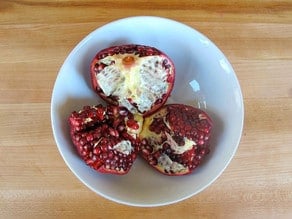 Pomegranate pulled into three sections.