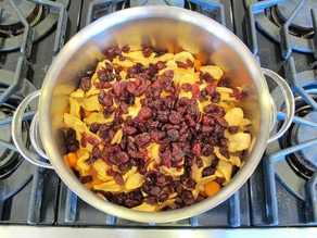 Dried apples and cranberries added to stockpot.