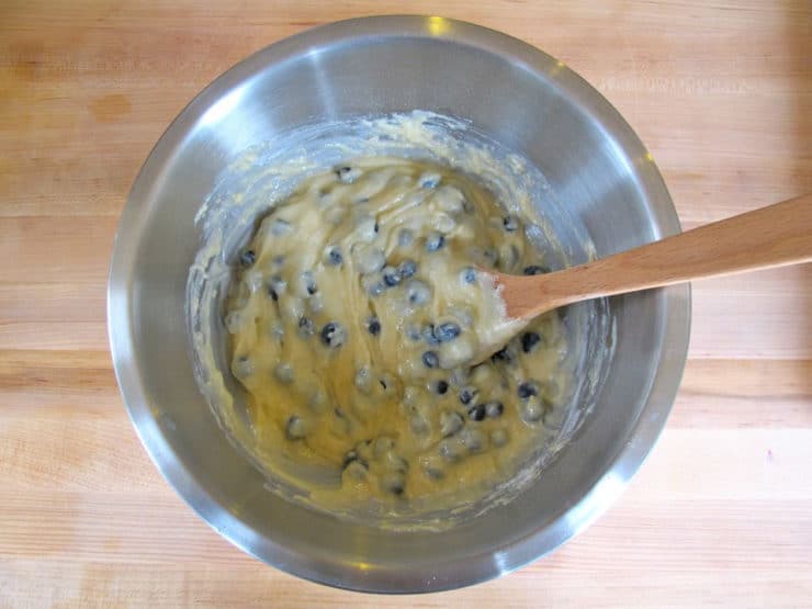 Fold blueberries into muffin batter in bowl.