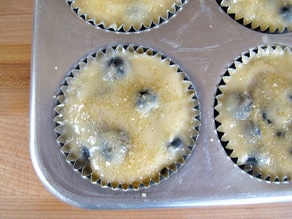 Add blueberries to the top of batter in muffin tin.