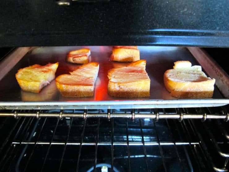 Broiling sliced challah.