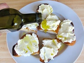 Drizzling olive oil over ricotta challah.