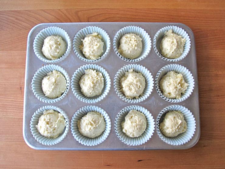 Cupcake batter in lined muffin tin.