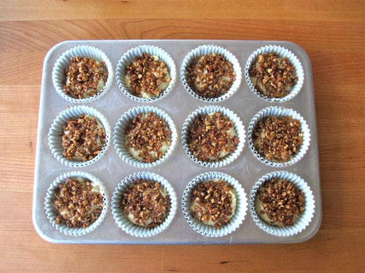 Streusel on batter in lined muffin tins.