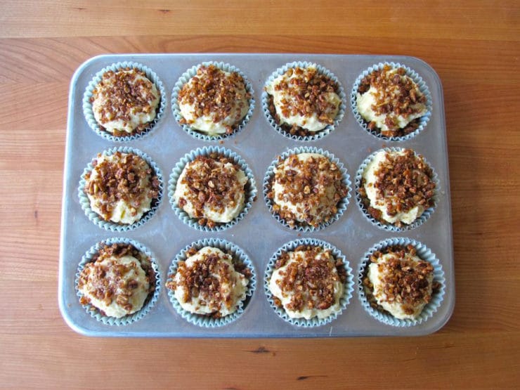 Streusel sprinkled on batter in lined muffin tin.